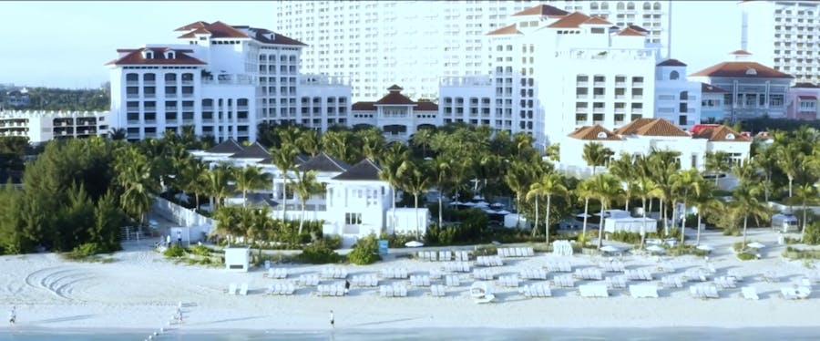 Elegant beachfront wedding ceremony at Rosewood Baha Mar with ocean views, white chairs, and tropical luxury setting