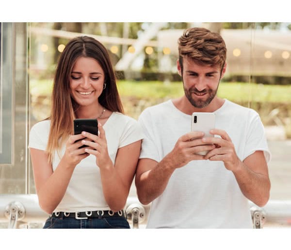 Couple Looking At Their Smartphone