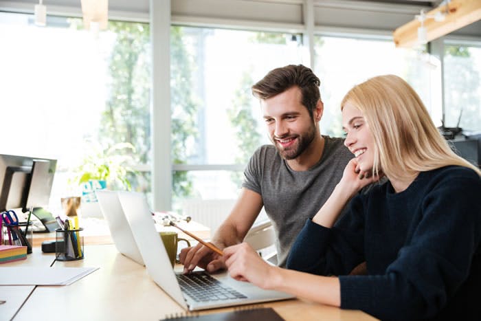 Couple Looking at the Platform on a PC Display