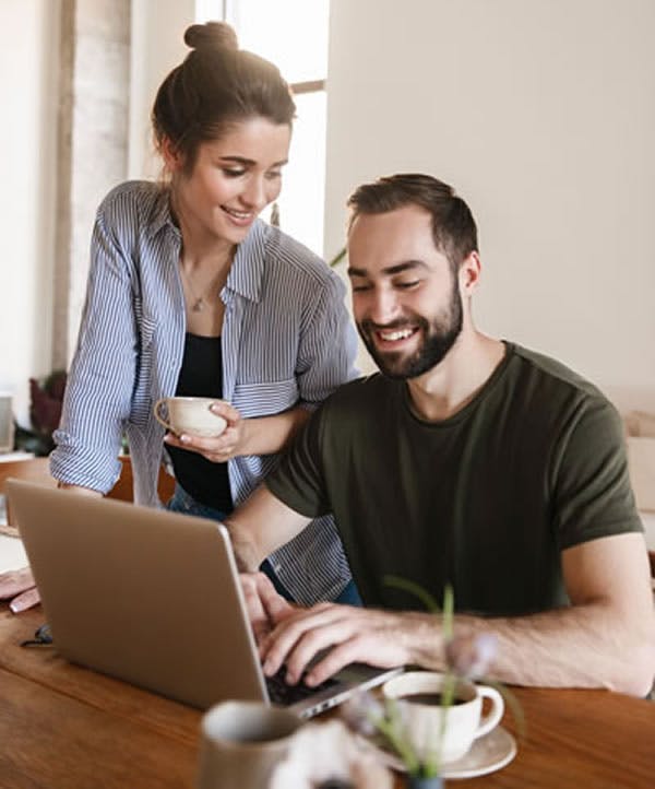 Couple Looking At PC Receiving Passive Income