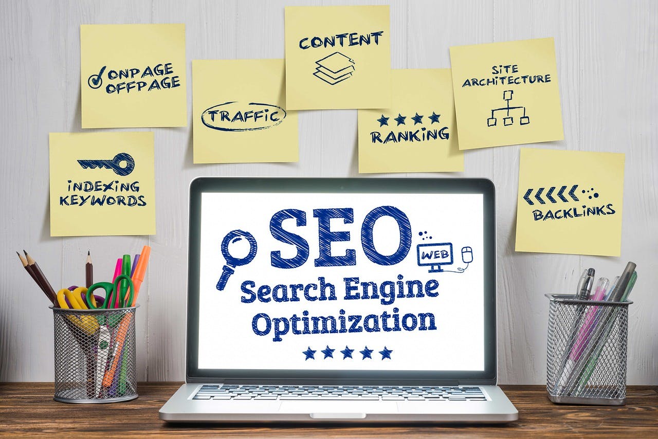 Laptop With SEO and Key SEO Tasks on Post-It Notes