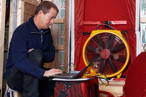 Energy Inspector Performs Blower Door / Envelope Pressure Test