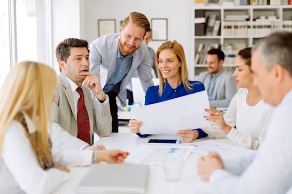 Group of business professionals discussing a project during a meeting in a modern office