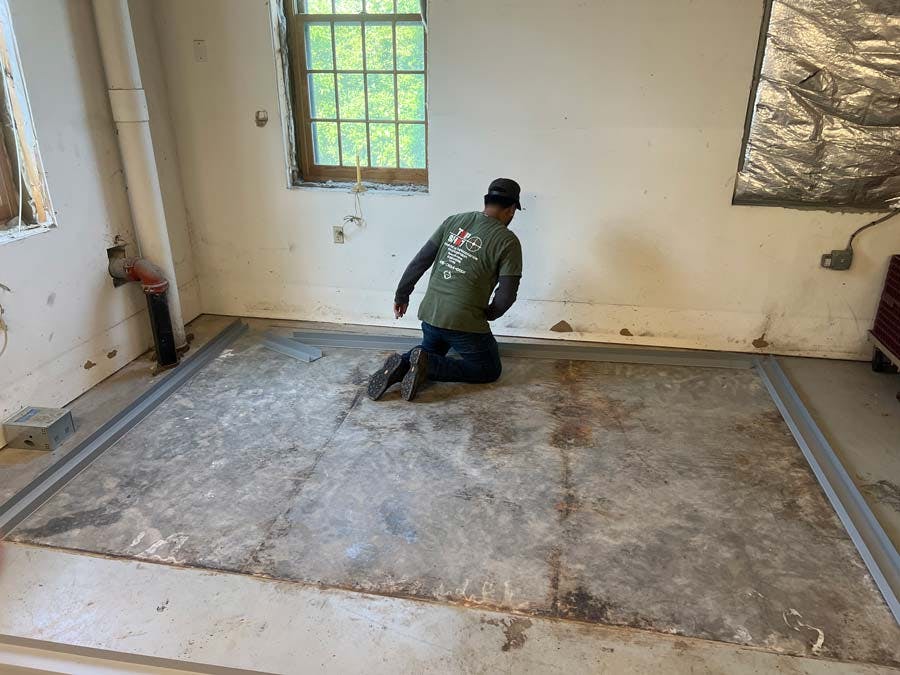 <span style="font-weight: 200;"> Technician Laying Out Base Frame for Walk-In Refrigeration Installation by TopShot</span>