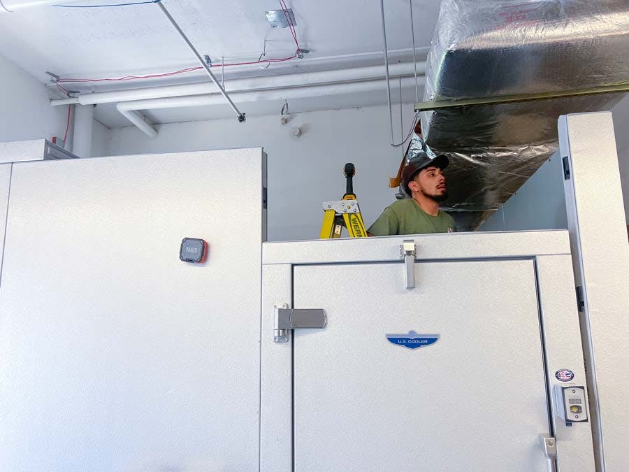 <span style="font-weight: 200;"> Panel Installation Over Door During Walk-In Freezer Setup by TopShot</span>