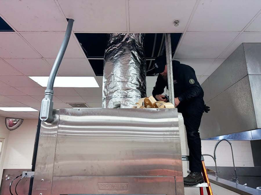 TopShot technician on-site installs a commercial ventilation system on the rooftop a professional kitchen.