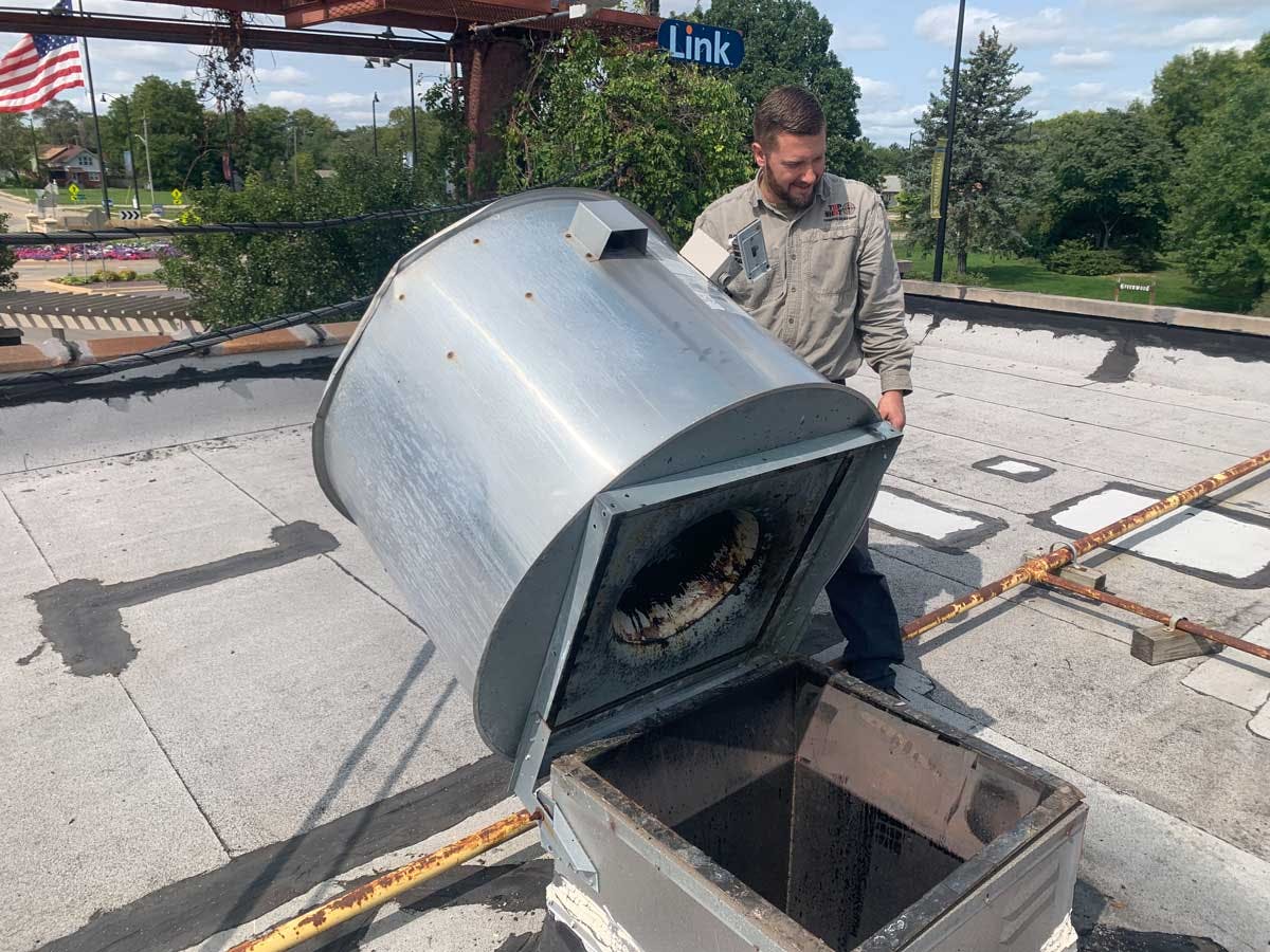 TopShot technician on-site services a commercial ventilation system on the rooftop a professional kitchen.